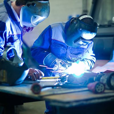 Welder master with trainee at work